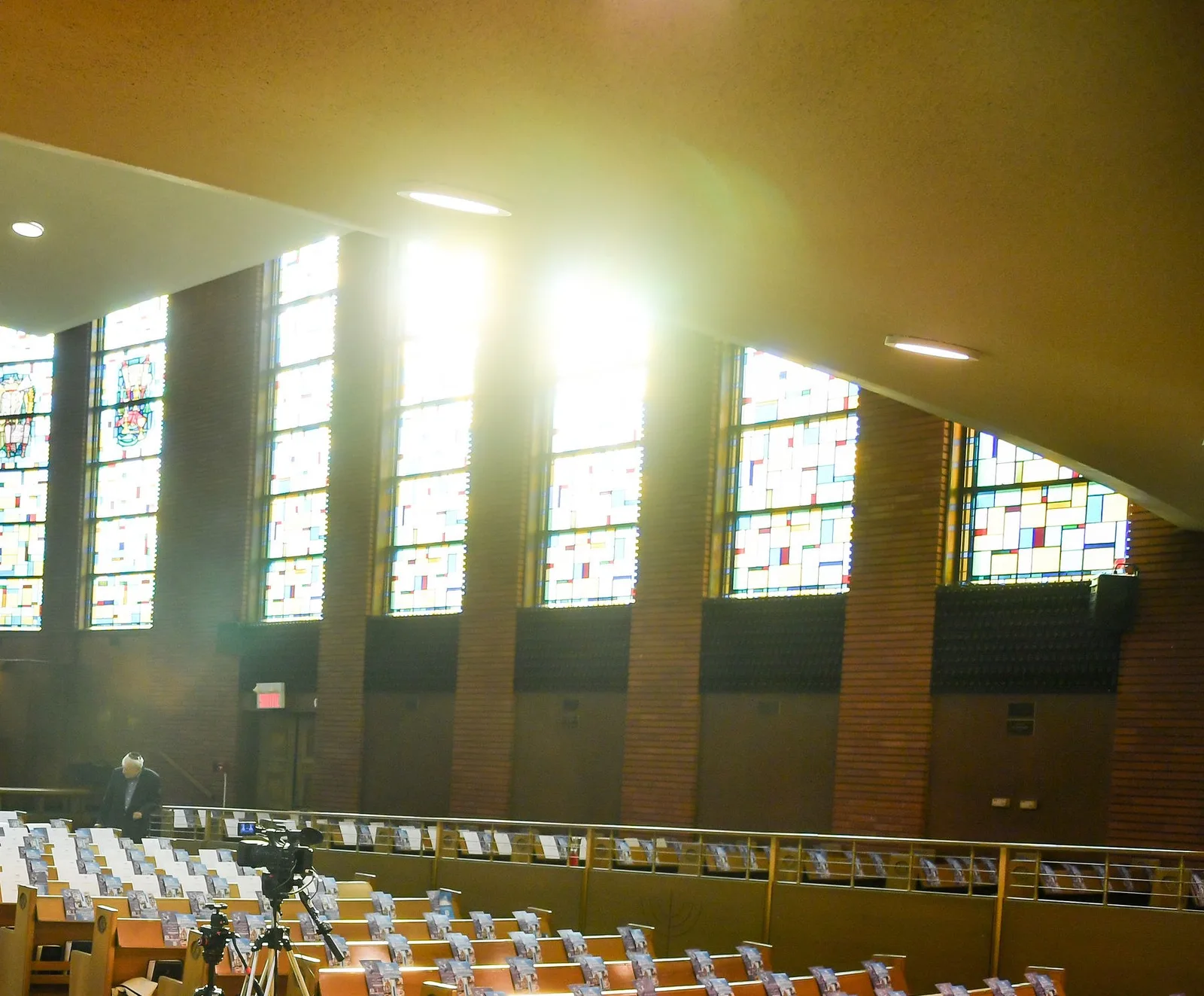 Late sun pouring through the sanctuary’s tall stained-glass windows
